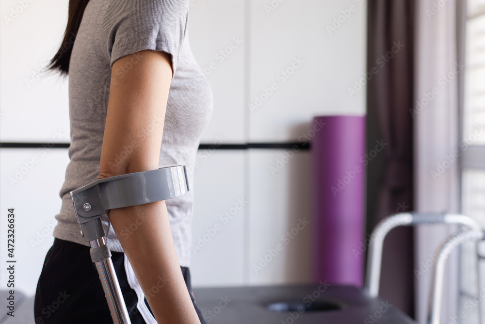 Disabled patient woman using crutches support walking at home,Rehabilitation and recovery concept Disabled patient woman using crutches support walking at home,Rehabilitation and recovery concept