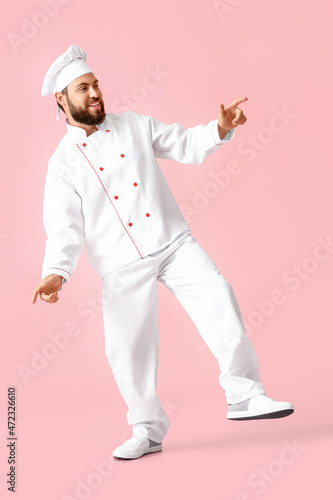 Dancing male chef on pink b...