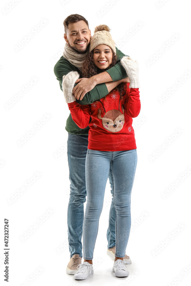 Happy couple in Christmas sweaters on white background Happy couple in Christmas sweaters on white background