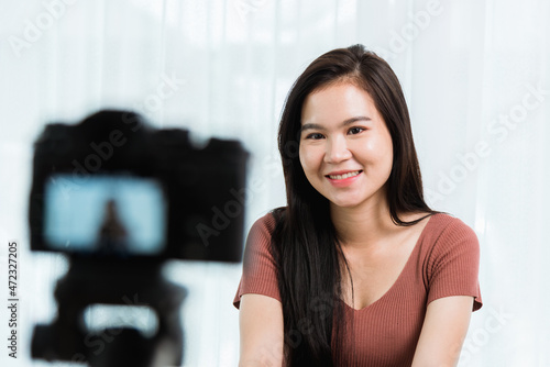 Work from home. Smiling Happy Asian young beautiful woman blogger with professional digital technology equipment live recording talking video call conferencing online videoblog channel