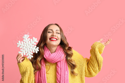 Happy woman holding snowfla...