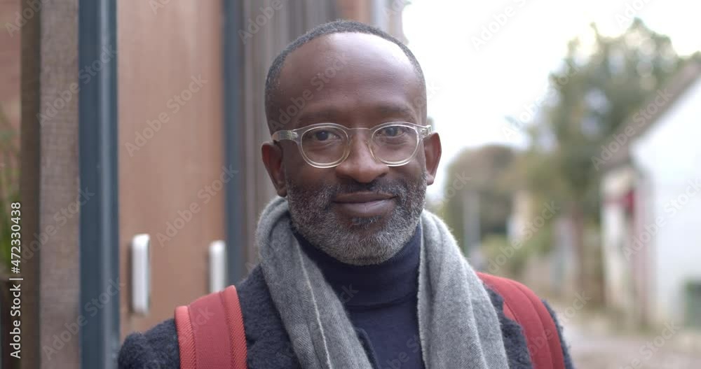 Portrait of male with spectacles standing outside in street Portrait of male with spectacles standing outside in street