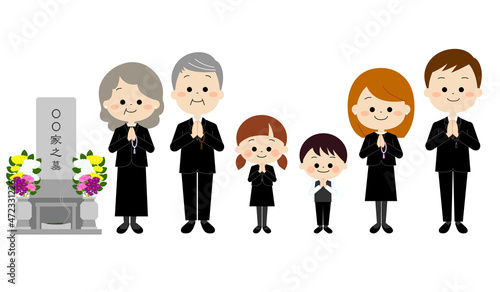 お墓参りをする喪服を着た家族（秋冬）