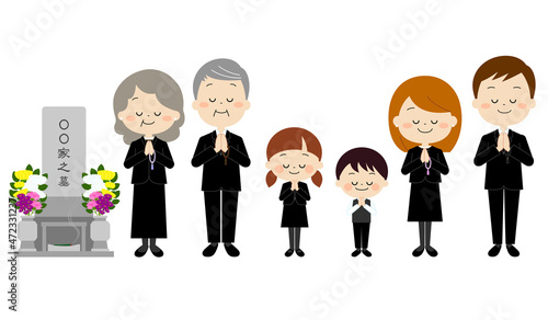 お墓参りをする喪服を着た家族（秋冬）