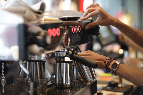 Barista s hands making a coffee with espresso coffee machine. Coffee shop concept