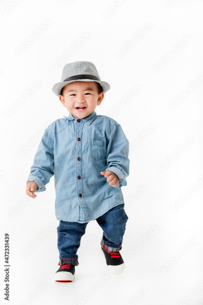 Lovely portrait of cute Asian little boy smiling on smart hat and handsome outfit with happy to play outdoors. Lovely portrait of cute Asian little boy smiling on smart hat and handsome outfit with happy to play outdoors.