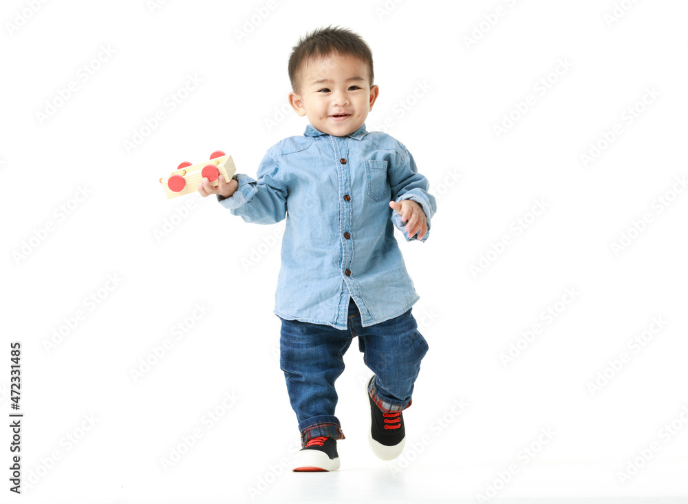 Portrait of cute Asian little boy fun with  handsome outfit posing happy to play with free. Attractive innocent kid looks healthy, cheerfully enjoy moment as childhood lifestyle