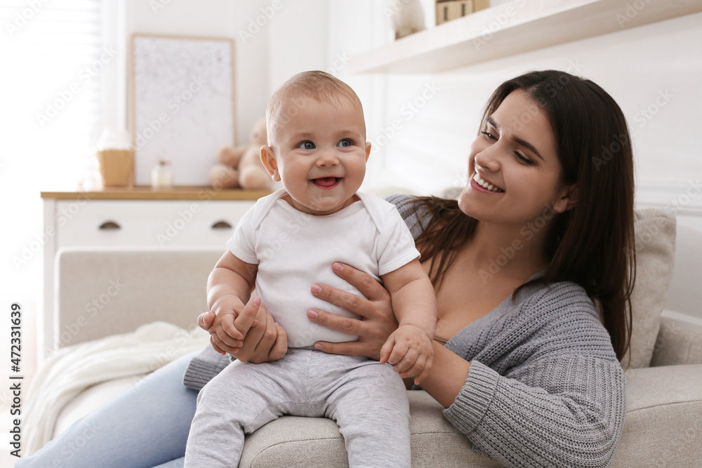 Happy young mother with her cute baby in living room Happy young mother with her cute baby in living room