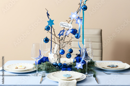 Beautiful table setting for Hanukkah celebration in dining room photo