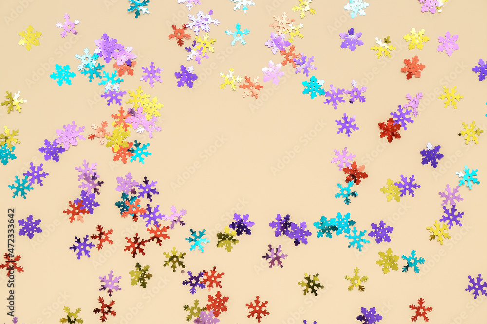 Frame made of beautiful confetti on color background