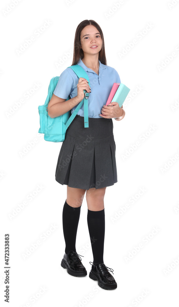 Teenage girl in school uniform with books and backpack on white background Teenage girl in school uniform with books and backpack on white background