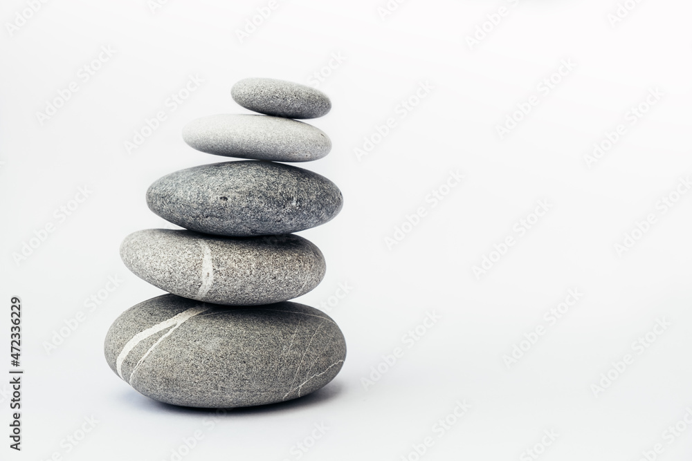 Stone cairn on light background, stones tower, simple poise stones. Purity harmony and Balance Concept. Place for text. Stone cairn on light background, stones tower, simple poise stones. Purity harmony and Balance Concept. Place for text.
