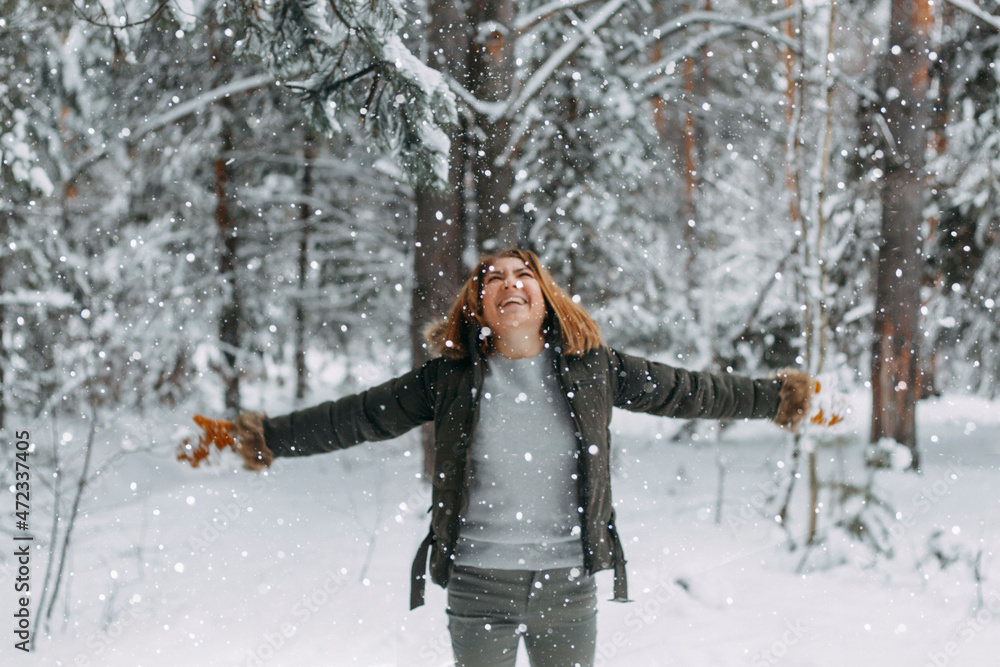 Snow in the air on the background of a blurry image of a happy young girl who throws white snow. Christmas holidays, Winter time Snow in the air on the background of a blurry image of a happy young girl who throws white snow. Christmas holidays, Winter time