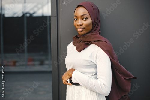 Portrait of young muslim woman wearing hijab looking at camera photo