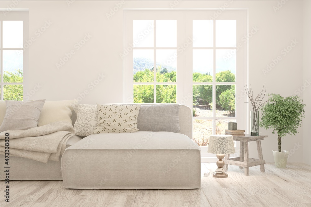 Fototapeta premium White living room with sofa and summer landscape in window. Scandinavian interior design. 3D illustration