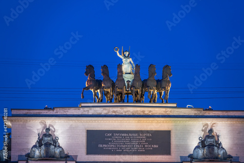 Sculptural group on top of the triumphal arch, six horses with the goddess of victory in the chariot on the roof of the Arch de Triumph in Moscow, Russia photo