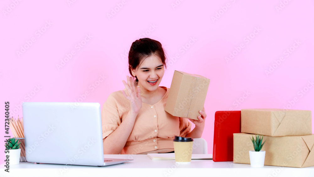 Studio shot of Asian happy successful professional young female startup entrepreneur businesswoman greeting say hi hello goodbye video call on tablet with global online customers pink background Studio shot of Asian happy successful professional young female startup entrepreneur businesswoman greeting say hi hello goodbye video call on tablet with global online customers pink background