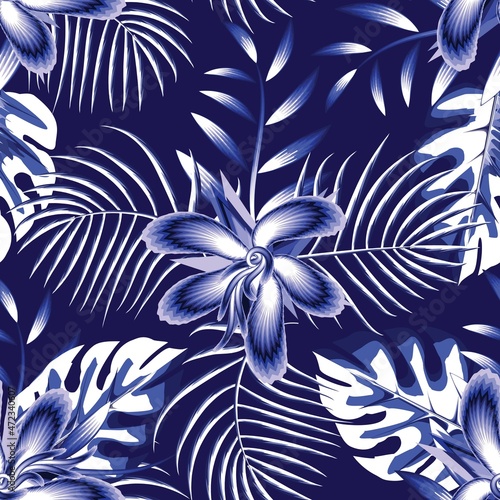 Fashionable abstract seamless backdrop with blue isolated tropical monstera palm leaves and hibiscus flowers plants foliage on dark background. Vector design. Jungle print. Floral background. Summer