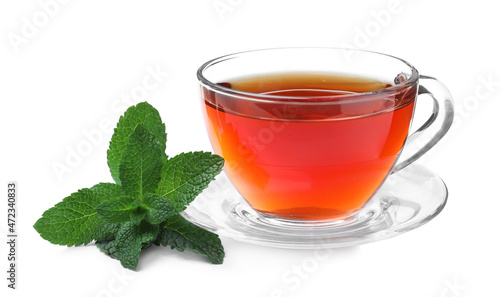 Cup of aromatic black tea with fresh mint on white background