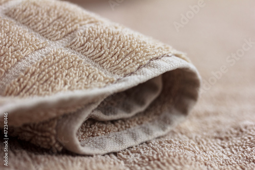 Beige, brown towel macro, soft bath blurred background, fabric material, copy space