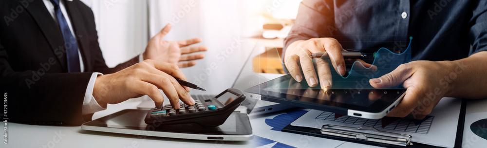 Obraz premium Image of businessmen hands during discussion of data in touchpad at meeting
