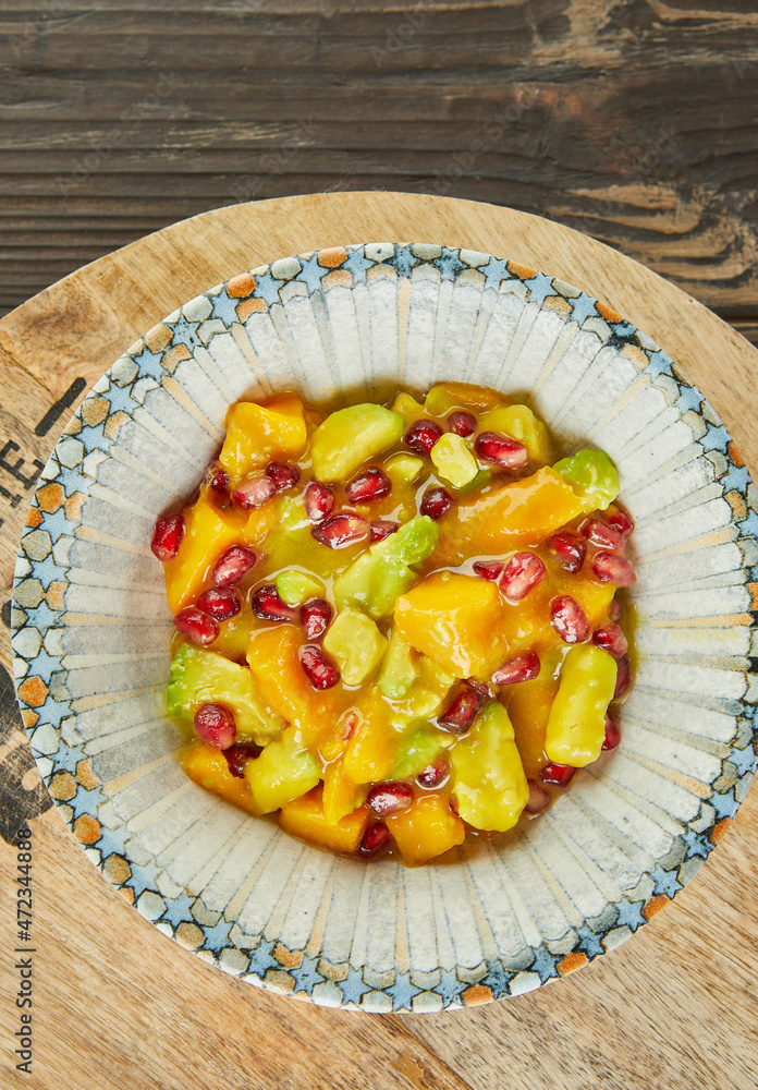 Mango salad with avocado and pomegranate seeds. French gourmet cuisine Mango salad with avocado and pomegranate seeds. French gourmet cuisine