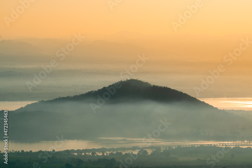 Mountain in the middle of "Pa Sak Lake" look like the island with light fog coverage during morning view from "Khao Phraya Dern Thong" Viewpoint at Lopburi province unseen Thailand.