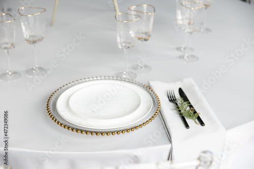 Wallpaper Mural Beautiful festive table setting. A luxurious dining set with cutlery, napkin, dishes and covered with a tablecloth in the restaurant. Gold plates and crystal glasses. A plate with a marble pattern. Torontodigital.ca