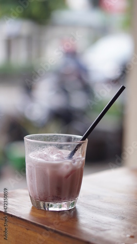 a glass of strawberry jam milkshake