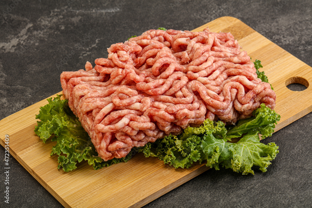 Raw pork minced meat over board Raw pork minced meat over board