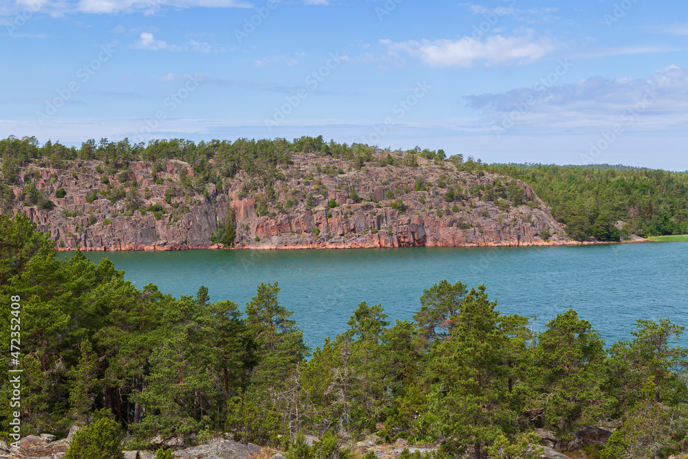 View of rocky and rugged coastline and sea in Åland Islands, Finland, on a sunny day in the summer.