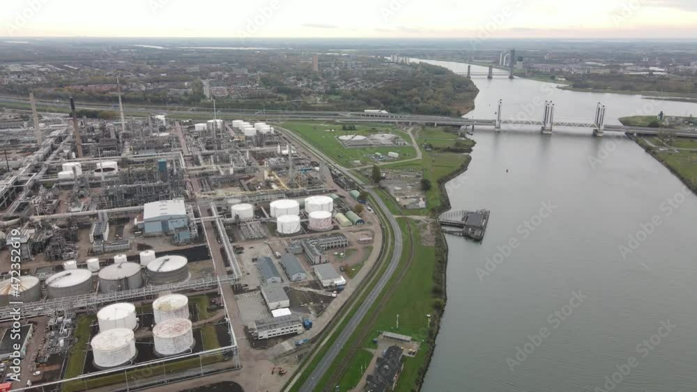 Container and silos in the Port of Rotterdam heavy industry and transportation along the Oude Maas Petroleum harbour aerial drone overview. Container and silos in the Port of Rotterdam heavy industry and transportation along the Oude Maas Petroleum harbour aerial drone overview.