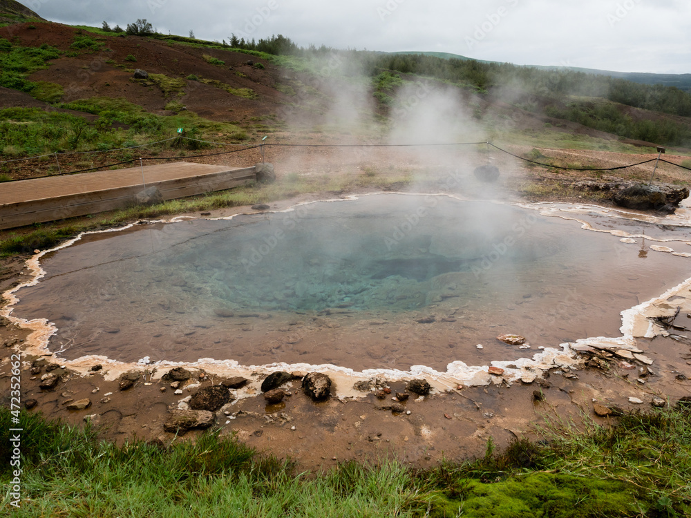 Fototapeta premium Steaming colorful hot spring pool in Geysir geothermal area, Iceland