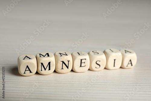 Wallpaper Mural Cubes with word Amnesia on white wooden table, closeup view Torontodigital.ca
