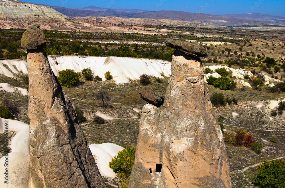 Scenic landscape view of unusual rock formations. Three sisters (Uc Guzeller) rock. Amazing shaped sandstone rocks. Popular travel destination in Turkey. UNESCO World Heritage Site