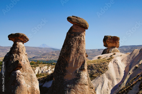 Scenic landscape view of unusual rock formations. Three sisters (Uc Guzeller) rock. Amazing shaped sandstone rocks. Popular travel destination in Turkey. UNESCO World Heritage Site
