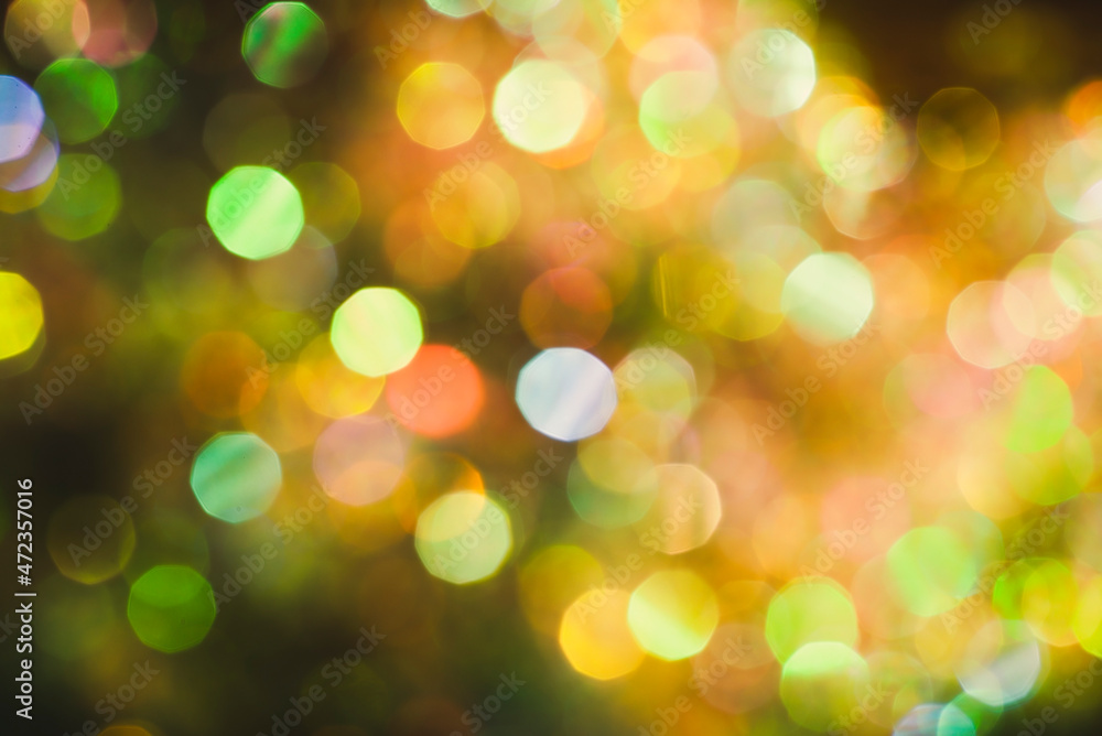 Obraz premium Beautiful natural bokeh of the colorful lights. Abstract Christmas New Year backdrop for text or advertising. Template for banner or party invitation