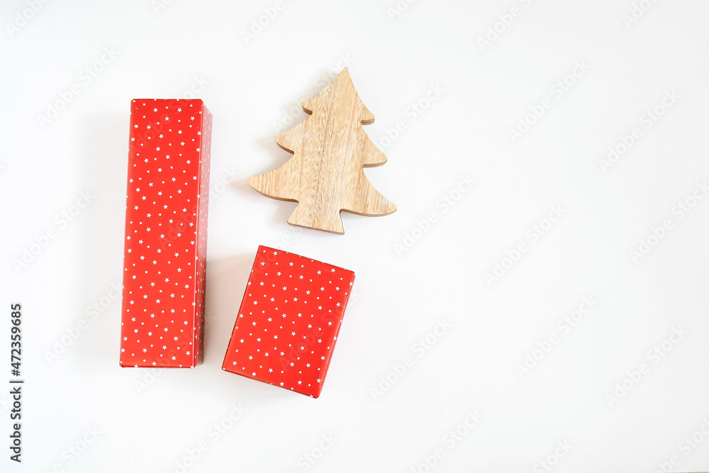 Obraz premium Christmas gift boxes wrap with red star paper and wooden pine tree on white background with space for text. Handmade objects , Christmas holiday concept.