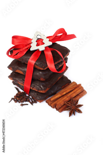 Stack of traditional italian Mostaccioli cookies tied with red ribbon isolated on white background photo