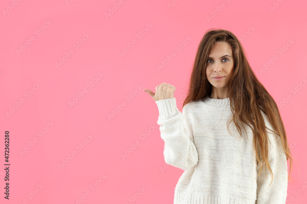 Attractive woman in sweater on pink background Attractive woman in sweater on pink background