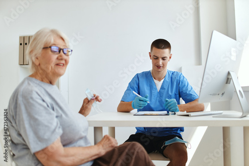 an elderly woman sitting in a doctor's office professional consultation