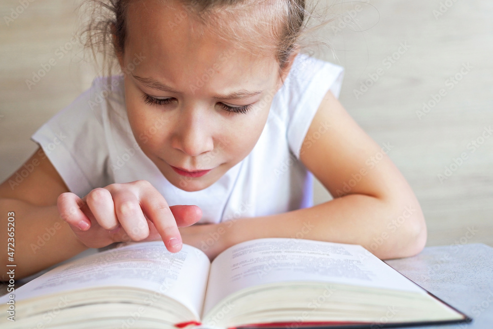 Schoolgirl girl reads books after school to know a lot Schoolgirl girl reads books after school to know a lot