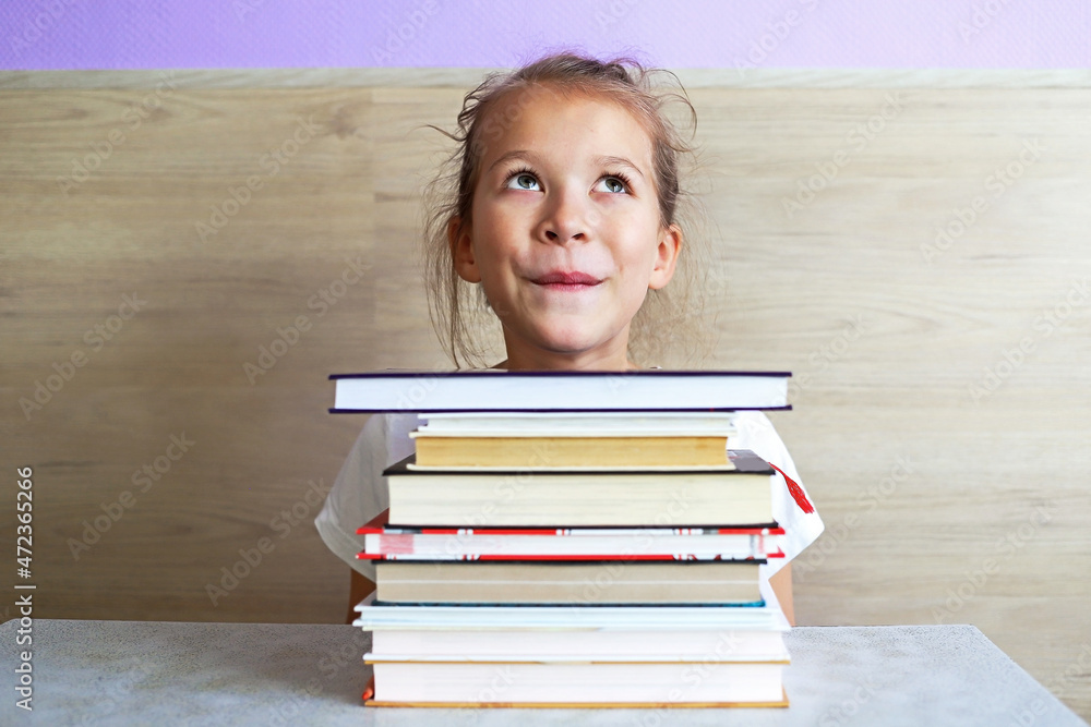 Schoolgirl girl reads books after school to know a lot Schoolgirl girl reads books after school to know a lot
