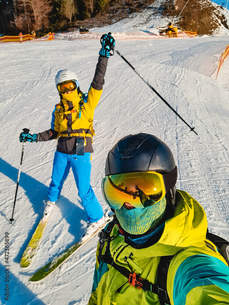 © phpetrunina14 - couple taking selfie at ski resort slope © phpetrunina14 - couple taking selfie at ski resort slope