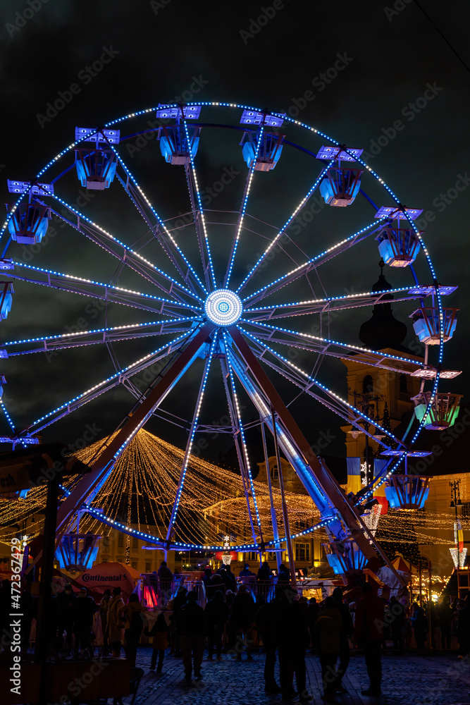 Colored Ferris Wheel at Christmas Market on a calm night