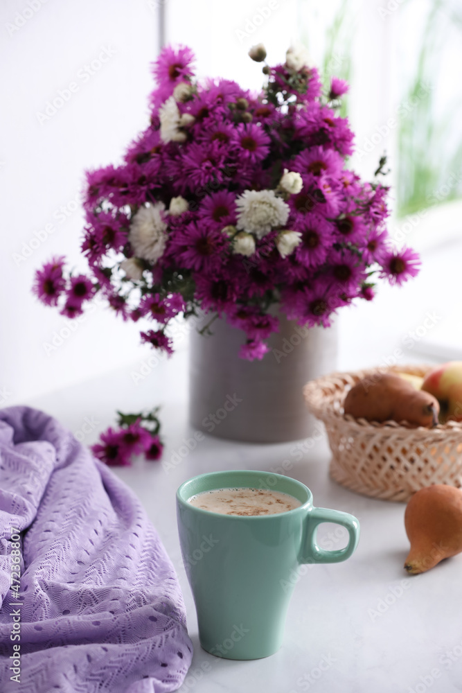 Cup of aromatic coffee, beautiful flowers and violet cloth on white table - obrazy, fototapety, plakaty 