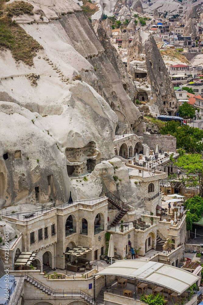Goreme, Turkey - panorama view of the town of Goreme in Cappadocia, Turkey with fairy chimneys, houses, and unique rock formations seen from sunrise point
