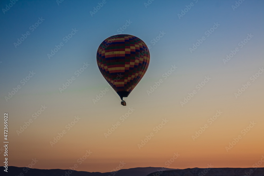 Hot air balloons flying over the valley at Cappadocia, Turkey. G