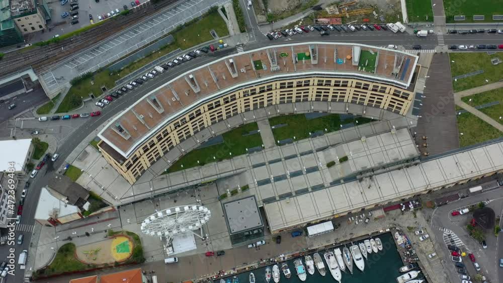 Aerial view a ferries wheel at the port of Savona, in Italy - tilt, drone shot Aerial view a ferries wheel at the port of Savona, in Italy - tilt, drone shot