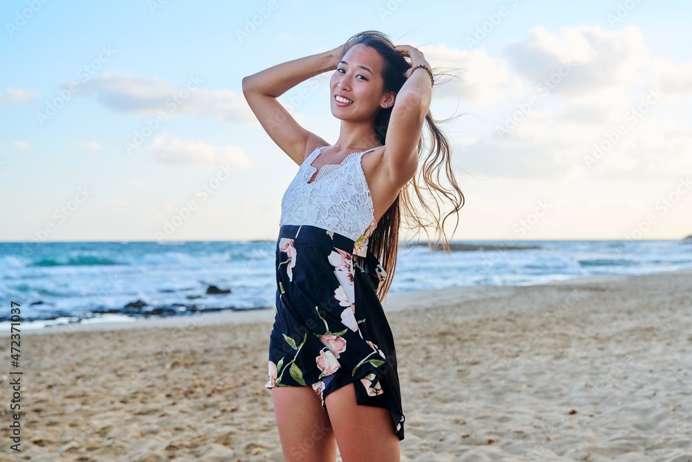 Beauty portrait of a beautiful young woman with long hair on the sea beach Beauty portrait of a beautiful young woman with long hair on the sea beach